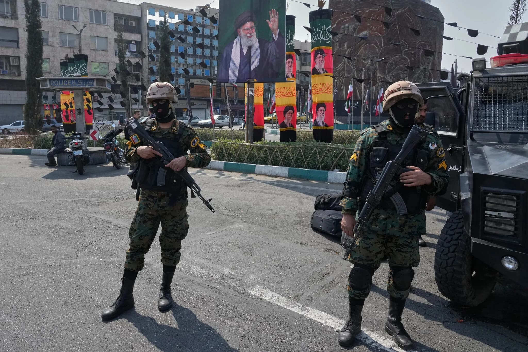 Policemen stand guard next to the banners showing portraits of the late Iranian Supreme Leader Ayatollah Ali Khamenei at the Islamic Revolution, square in downtown Tehran, Iran, on March 14, 2026. Photo: AFP
