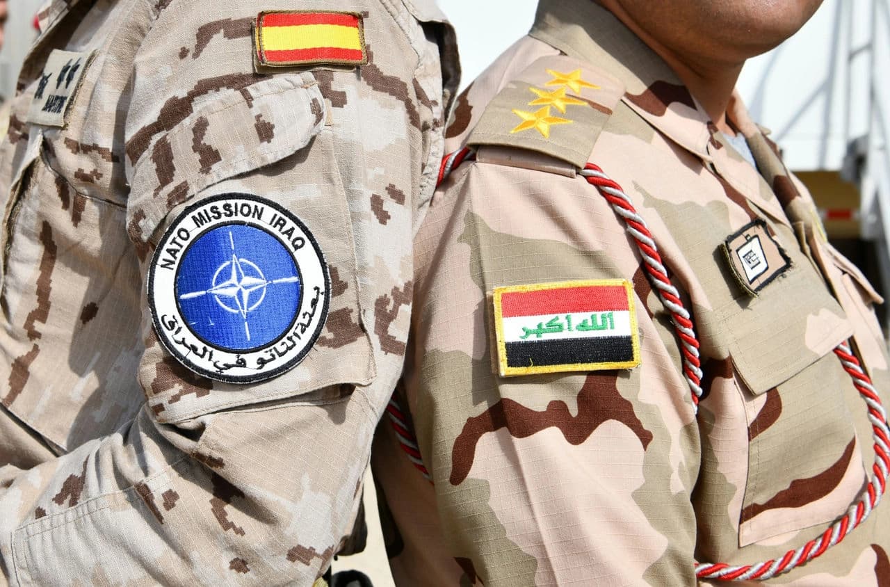 Iraq and NATO patches on the shoulders of two soldiers. Photo: NATO