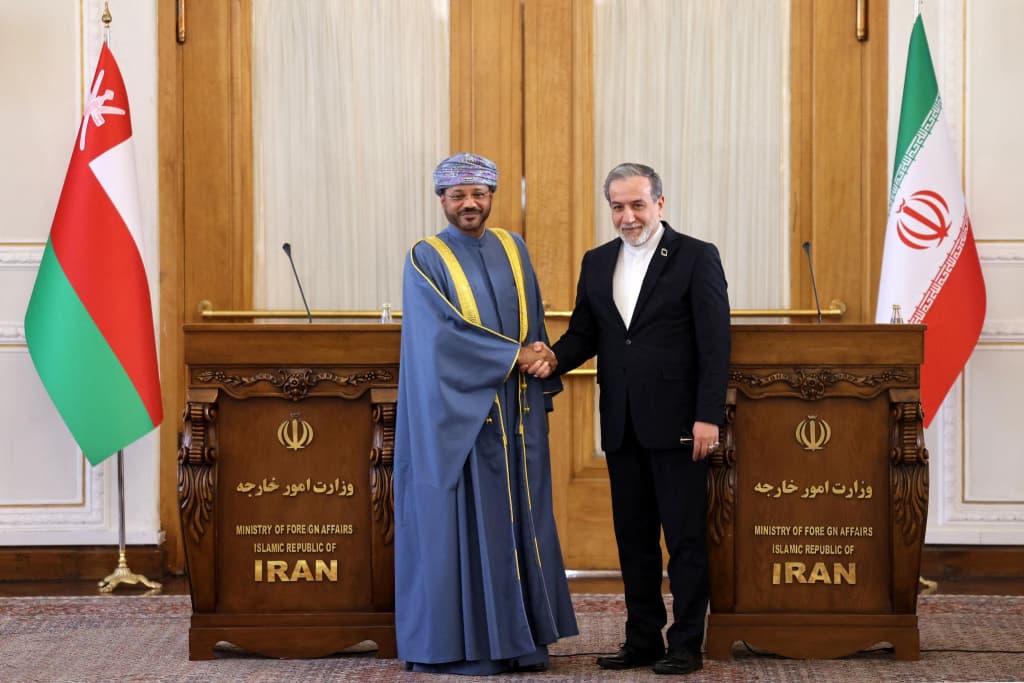 Iran’s Foreign Minister Abbas Araghchi (right) and Oman’s Foreign Minister Badr al-Busaidi shake hands after a joint press conference in Tehran on December 30, 2024. File photo: AFP