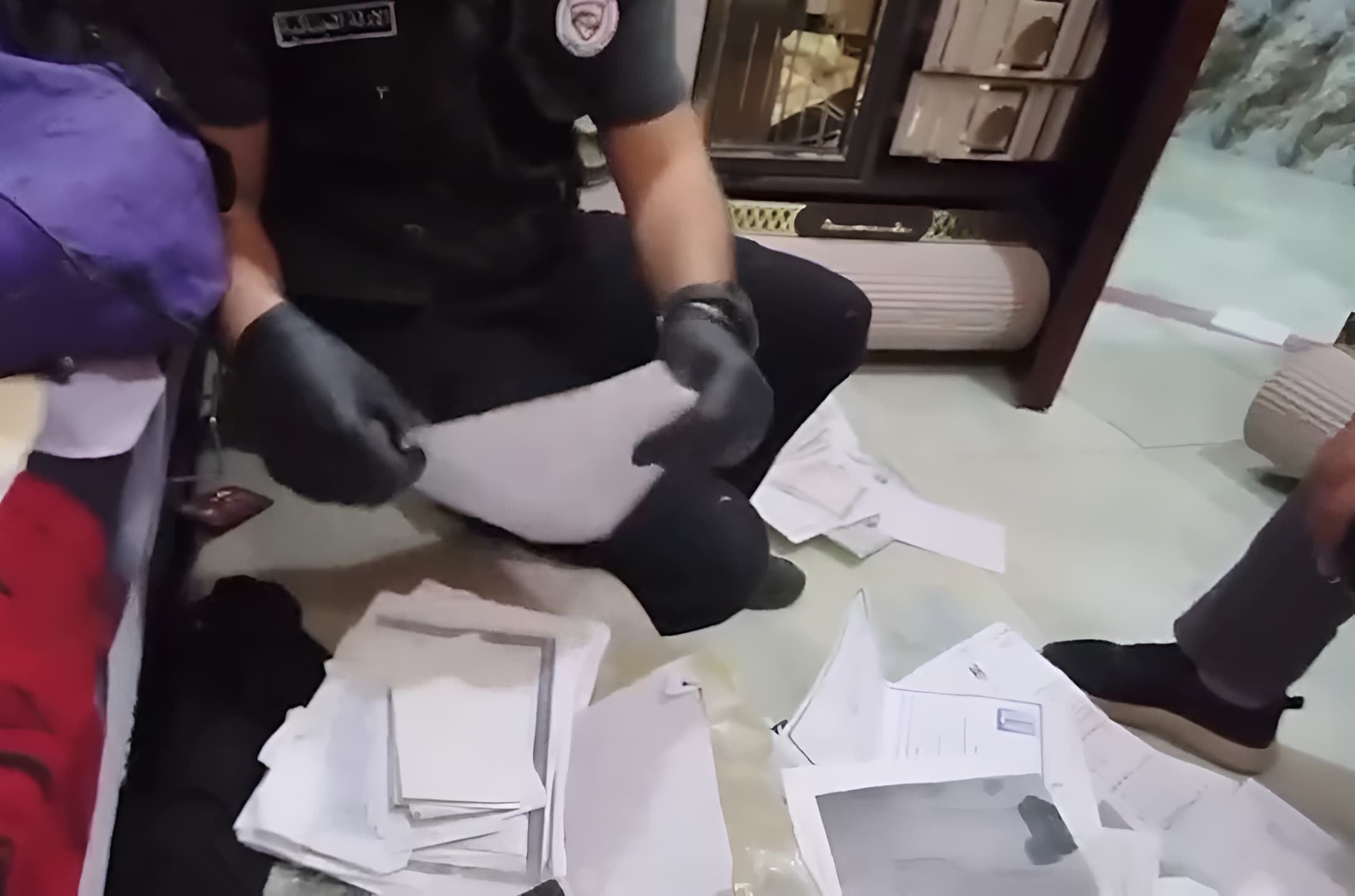 An Iraqi National Security Council (INSS) officer confiscating forged land plot transactions, records, and real estate registrations documents in Muthanna province, Iraq on August 27, 2026. Photo: Screengrab/INSS