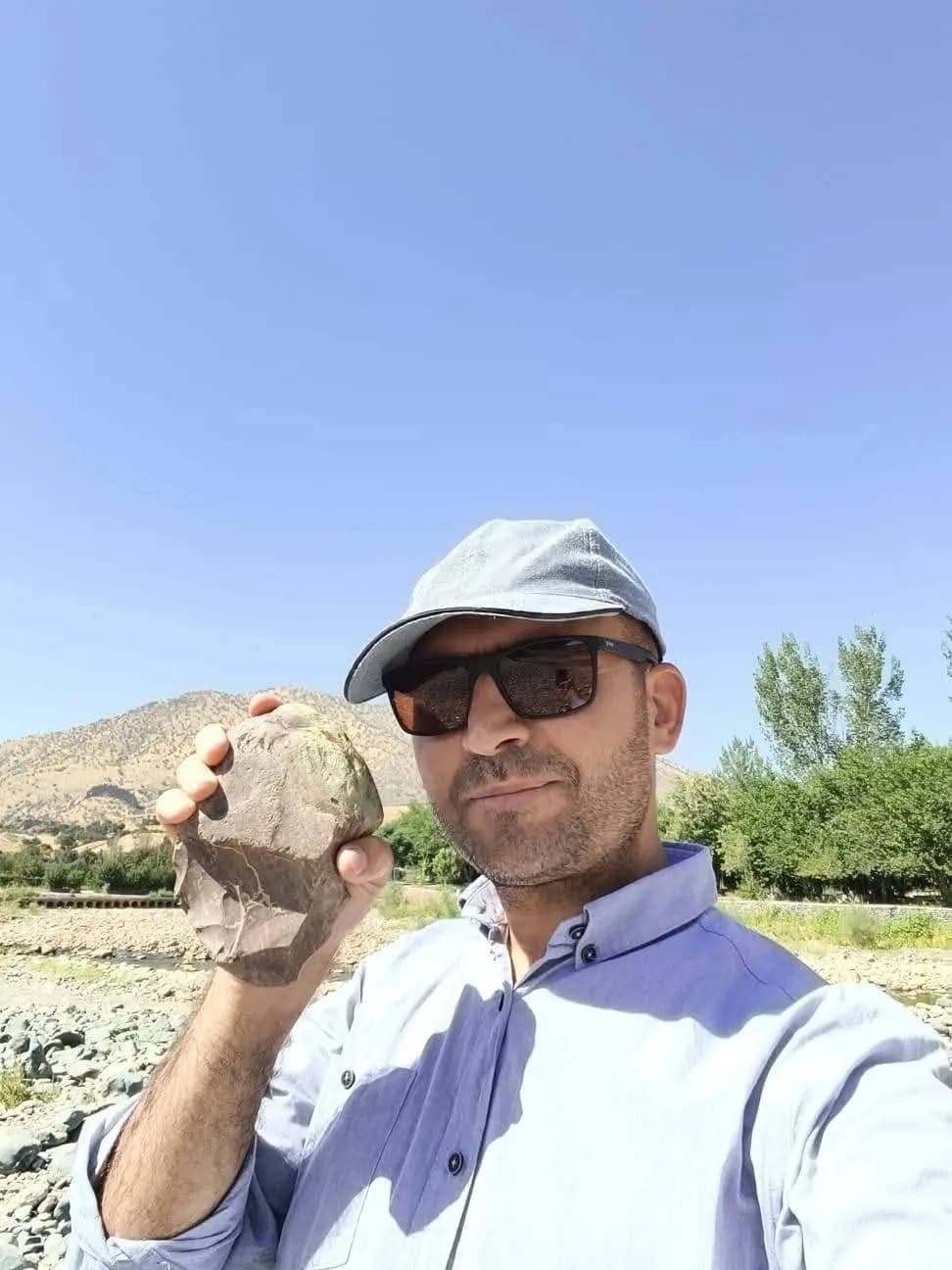 Dr. Dilshad Zamua, professor at the University of Sulaimani's Archaeology Department, holding a 200,000-year-old stone tool. Photo: Handout