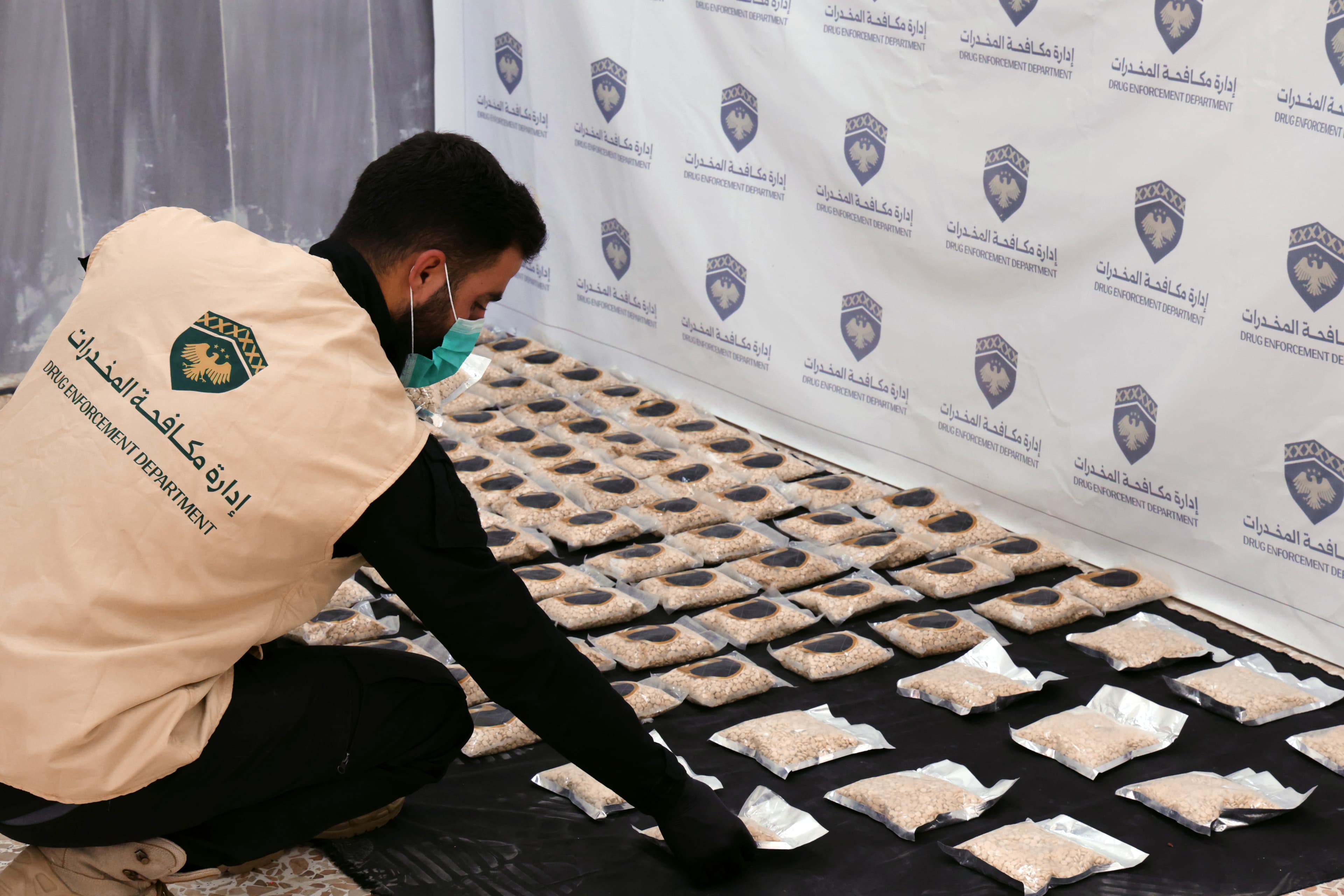 Syrian anti-narcotics directorate personnel laying down Captagon seized by the directorate on September 30, 2026. Photo: Syrian anti-narcotics directorate