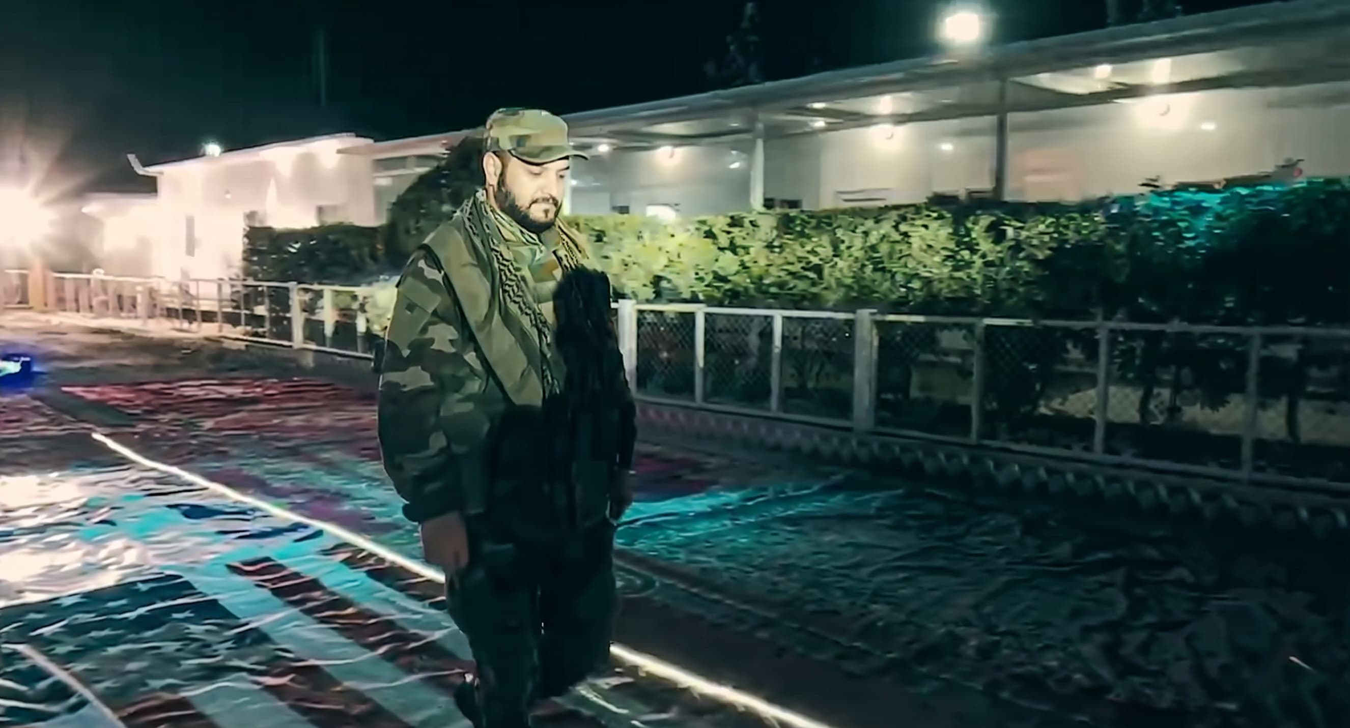 Akram al-Kaabi, leader of Harakat Hezbollah al-Nujaba tampling the US flag in an undated video. Photo: screengrab/Kaabi's X account.