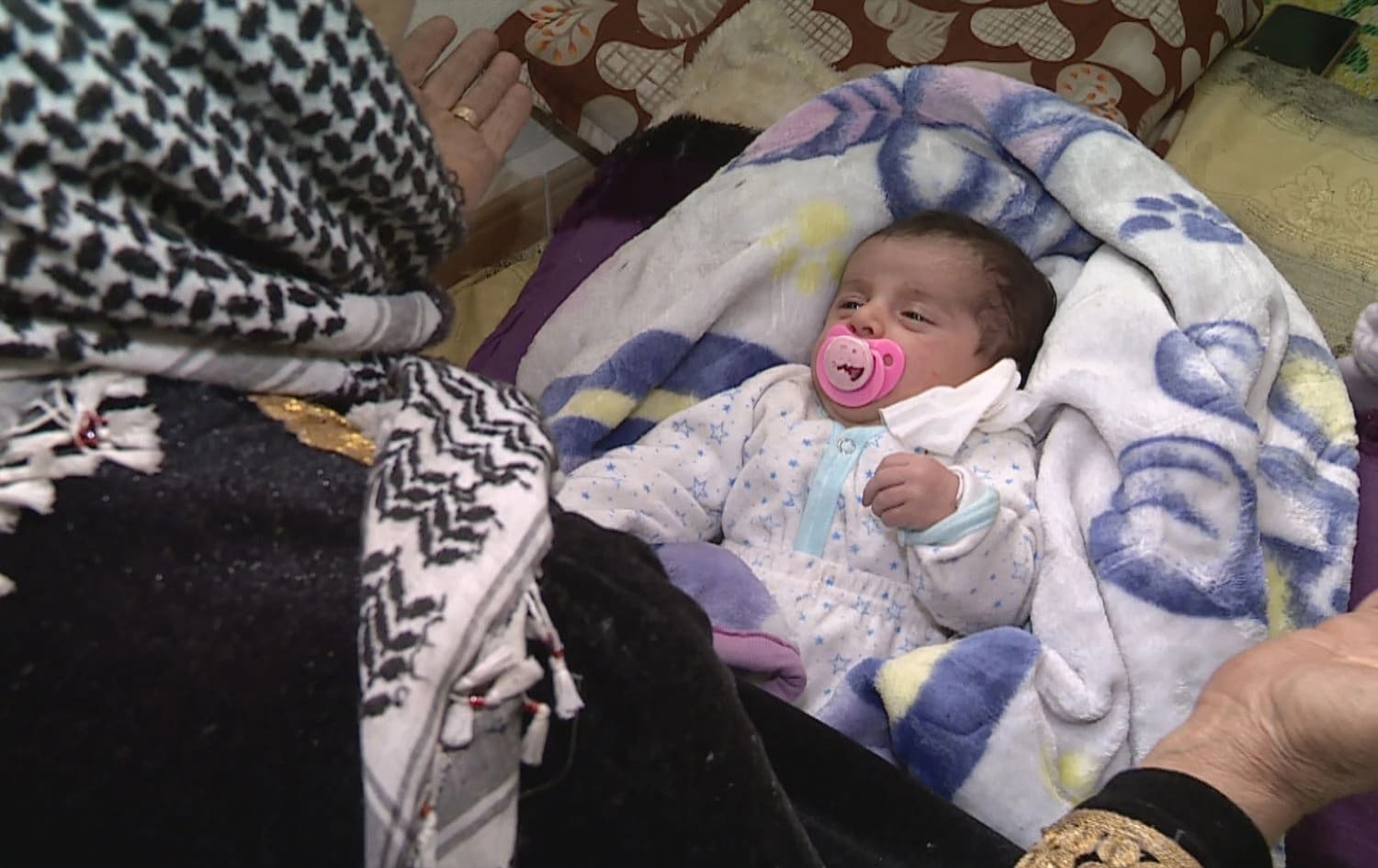 Displacement leaves infant orphaned as fighting drives families from Rojava