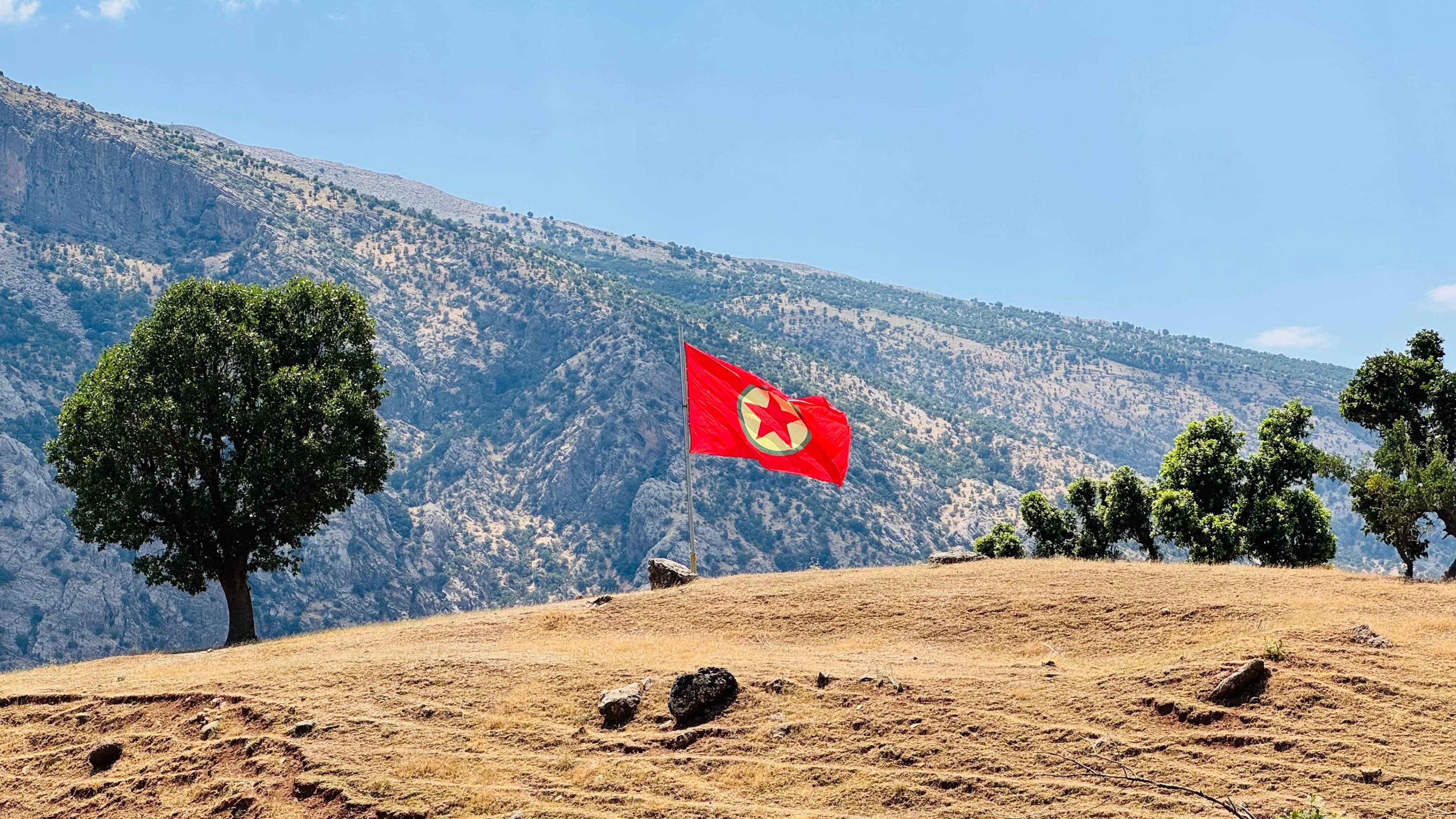 PKK flag flutters in the wind in the Qandil Mountains, June 2026. Fazel Hawramy