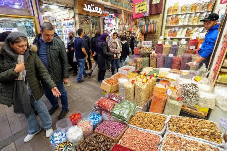 People look at goods in a Tehran market on March 12, 2024, as they prepare for Nowruz. Photo: AFP