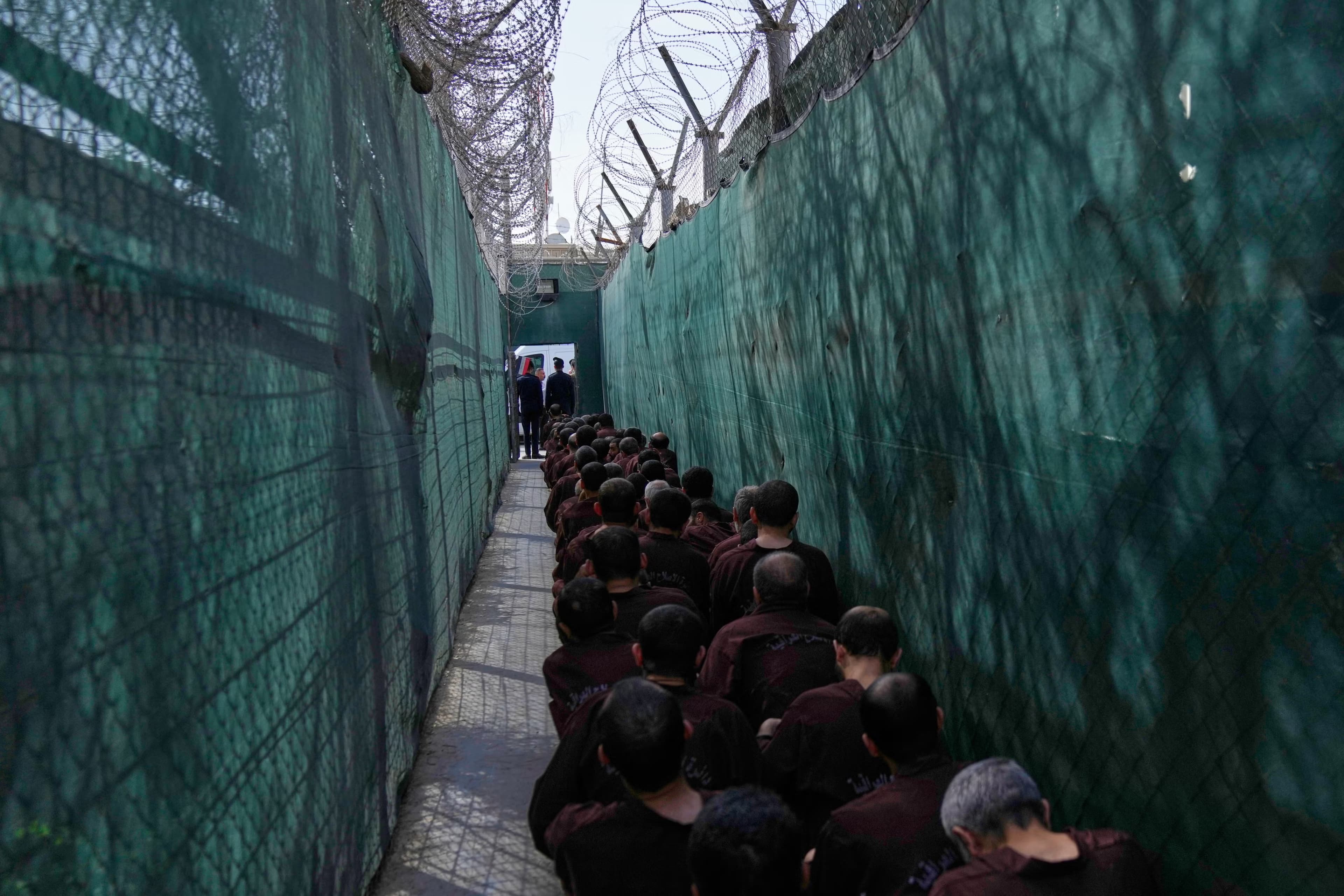 Men suspected of links to ISIS await questioning at Baghdad’s al-Karkh prison following their transfer from Rojava in February 2026. Photo: AP