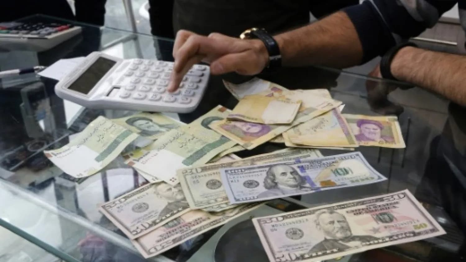 Money at a currency exchange office in a shopping center in the Iranian Capital Tehran. File Photo: AFP
