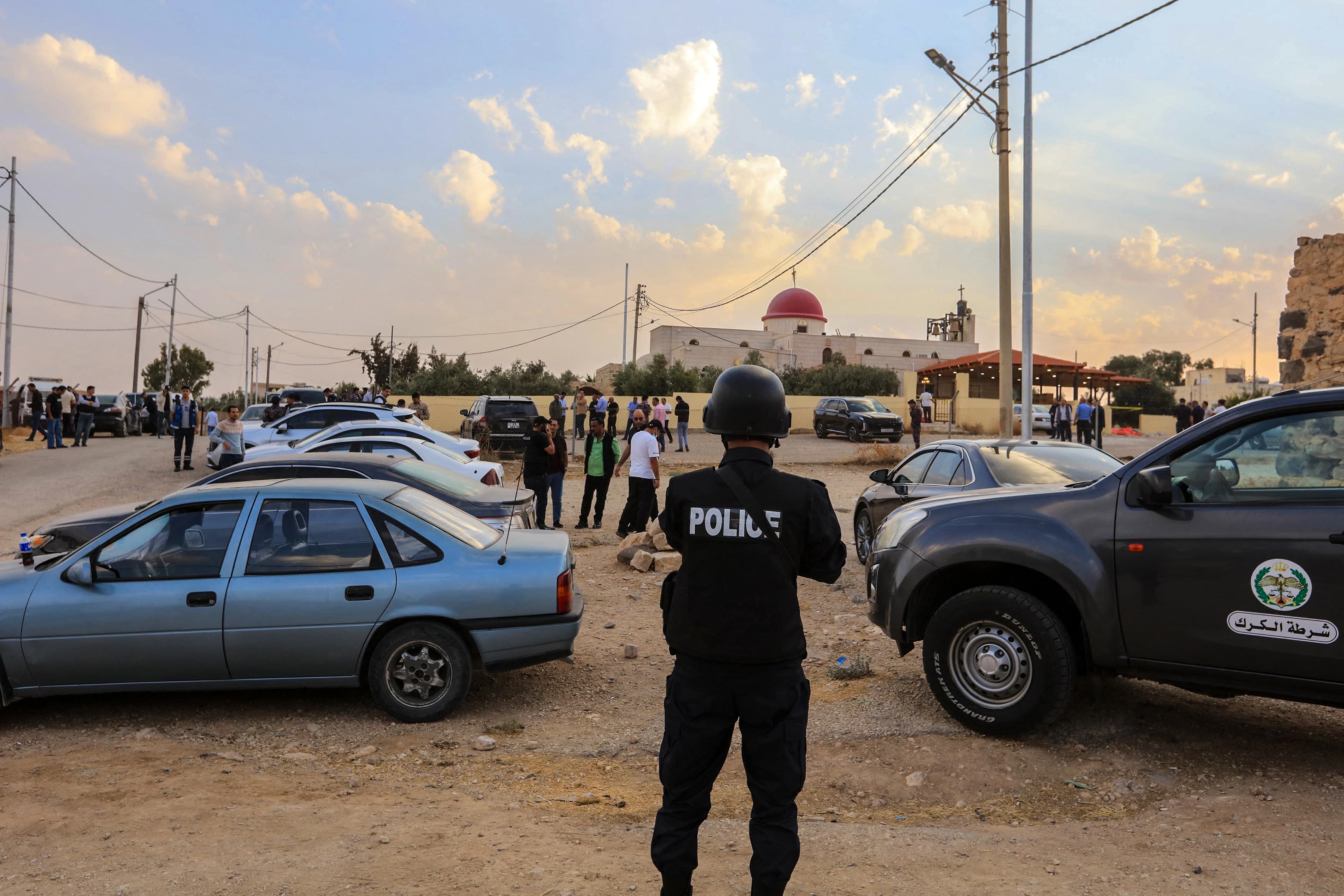 People and security forces gather outside a Greek Orthodox Church in the village of Hammoud in Jordan's Karak governorate following a shooting on October 23, 2026. Photo: AFP